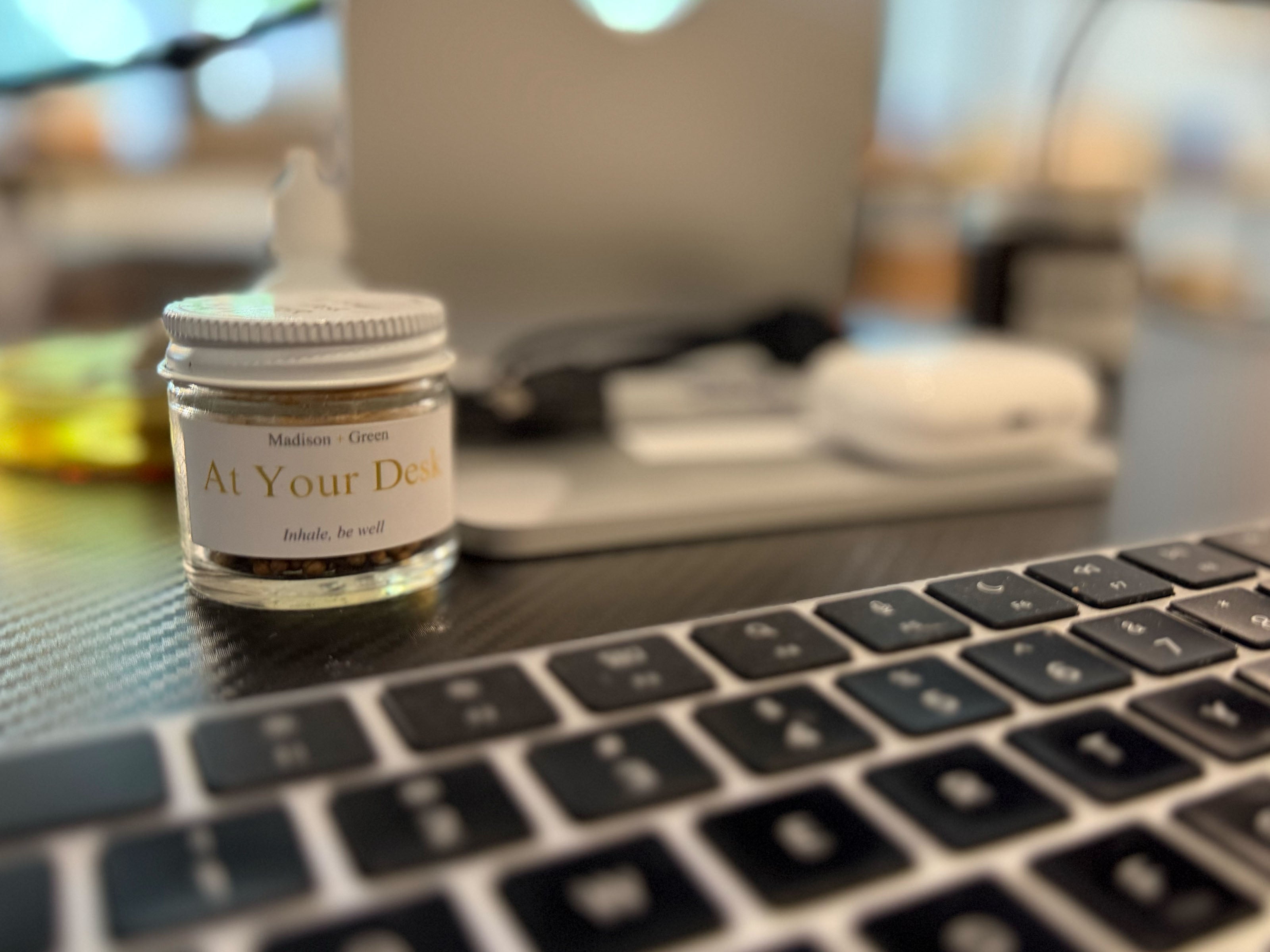 An aromatherapy inhaler resting beside a keyboard on a desk.