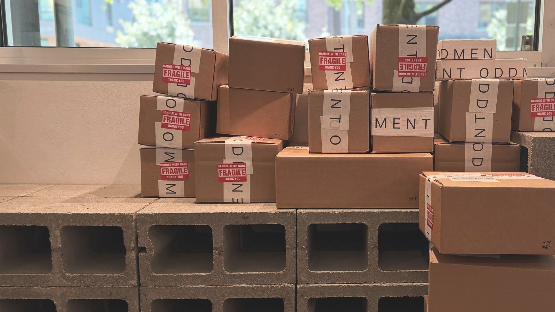 Stacked shipping boxes and outgoing customer orders prepared for dispatch at the Oddment shop.