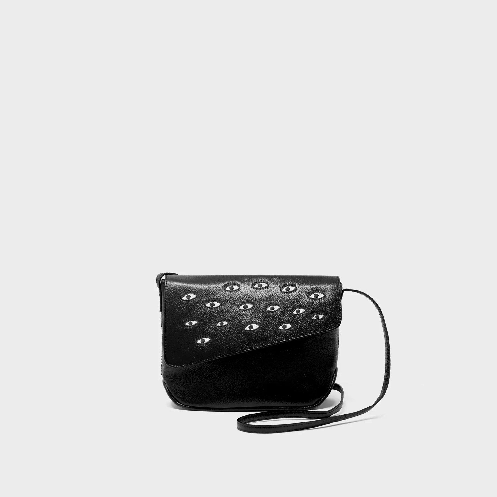 Black handbag with eye-shaped embroidery on a light gray background