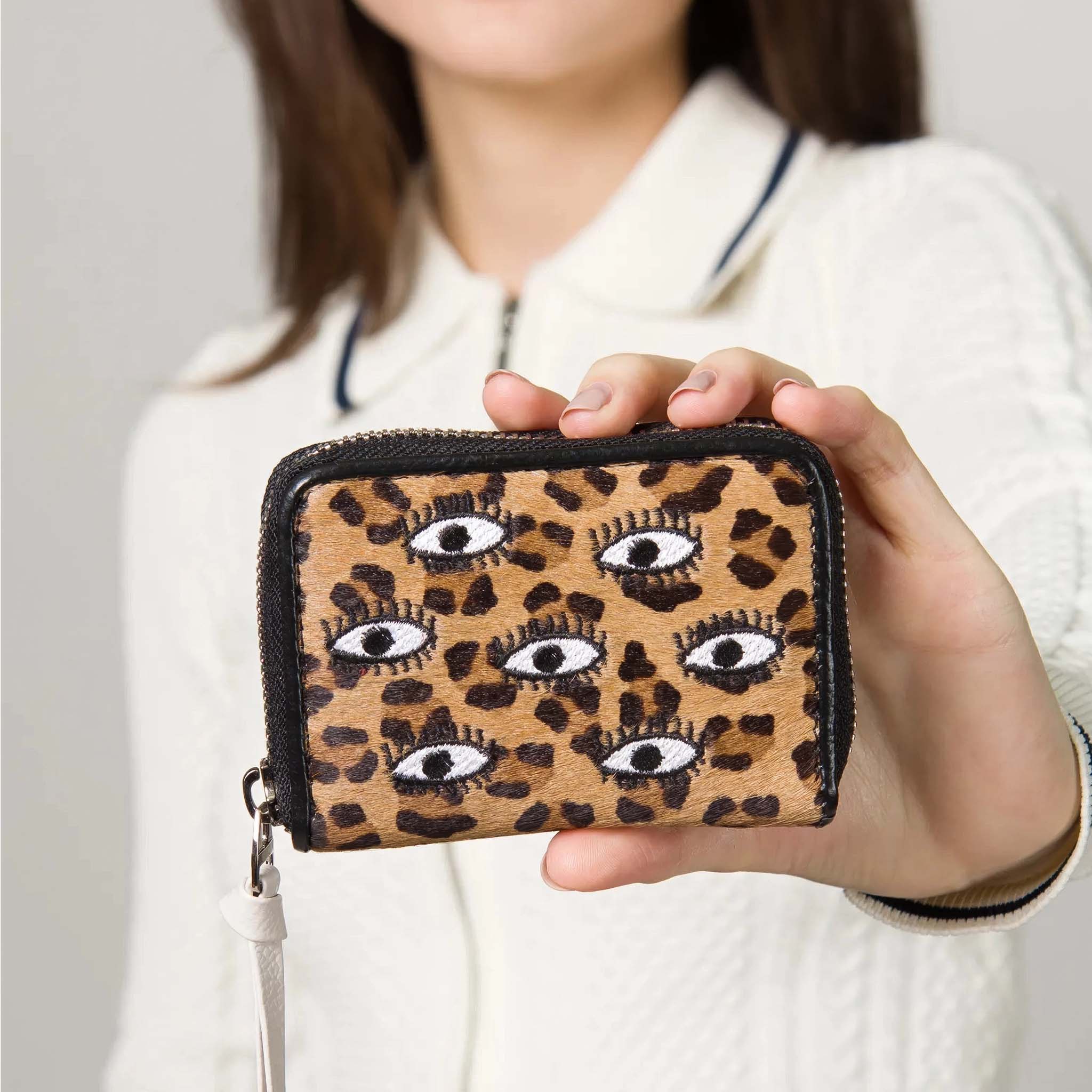 Person holding Min & Mon' Frodo Animal Print Leather Zip Around Wallet - All Over Eyes Embroidery
