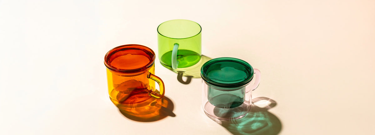 Three colorful glass cups on a light background