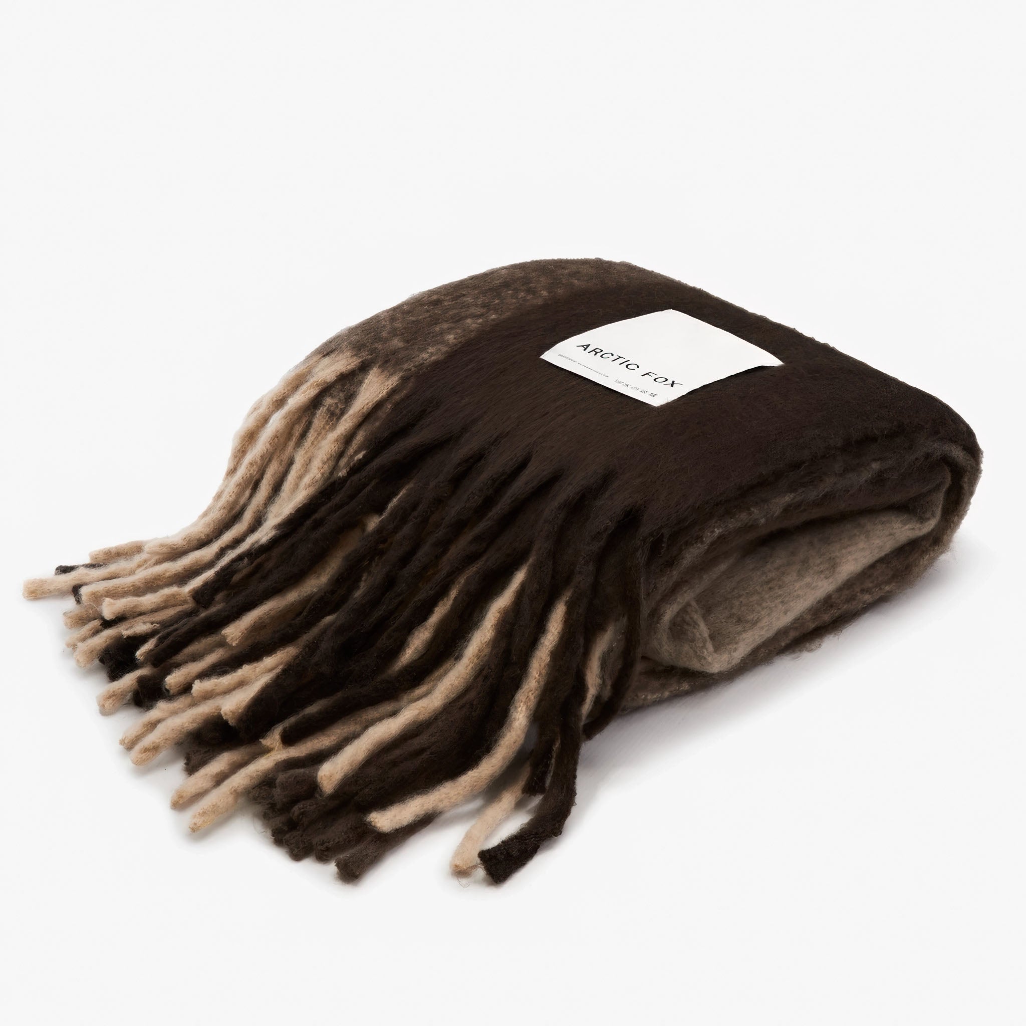 Folded plaid throw with brown, beige, and white pattern on a white background