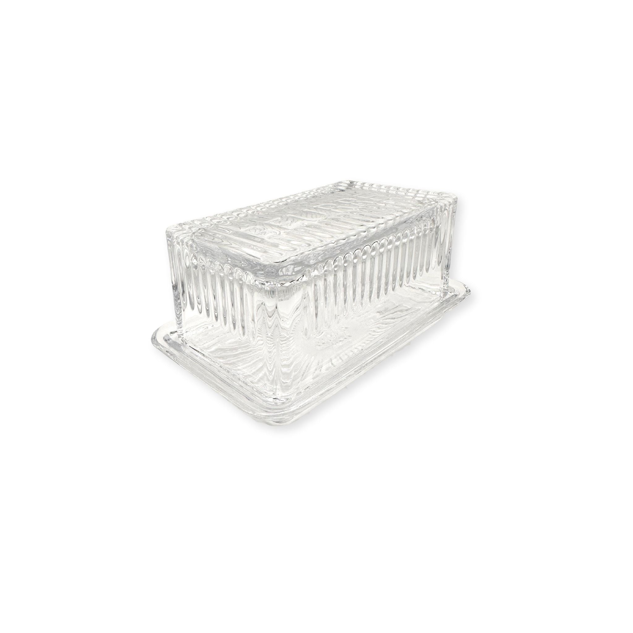 Clear glass beurre dish on a white background