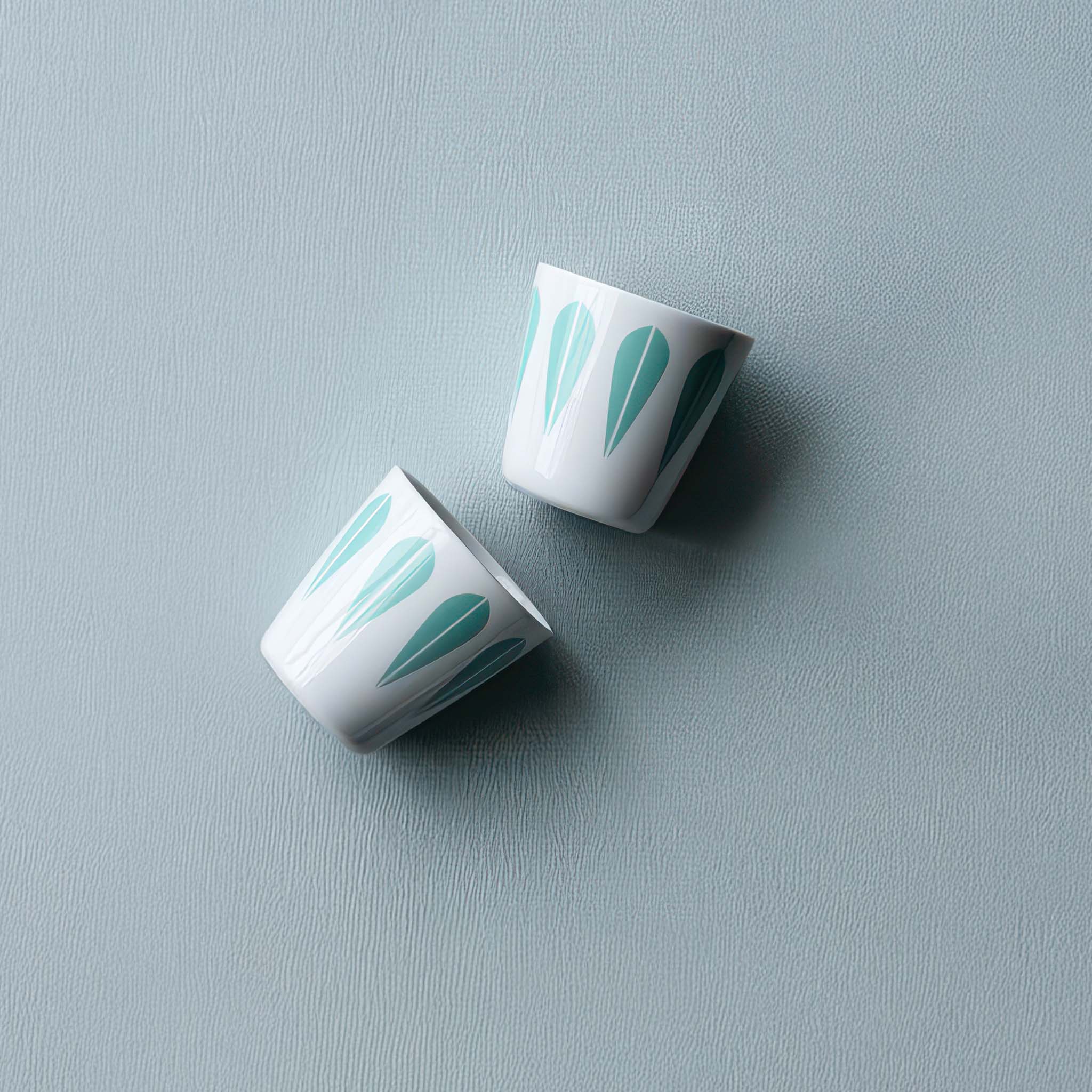 Image of two Arne Clausen Lotus cup in mint green on a baby blue background