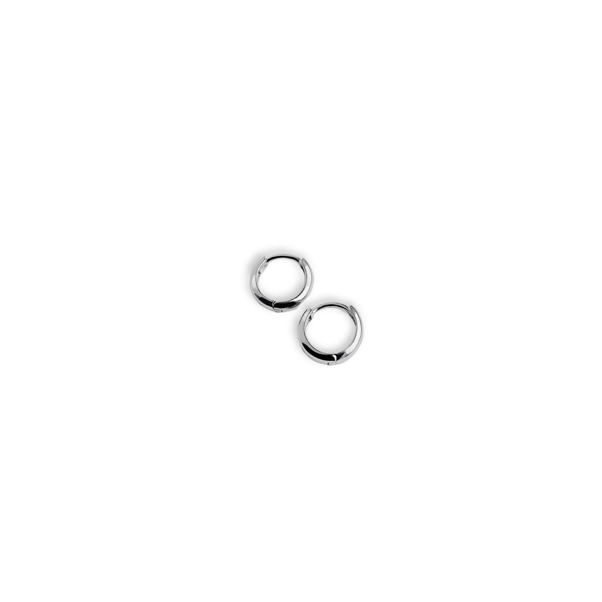 Full view of Kara Yoo's Norma Huggie hoops in silver