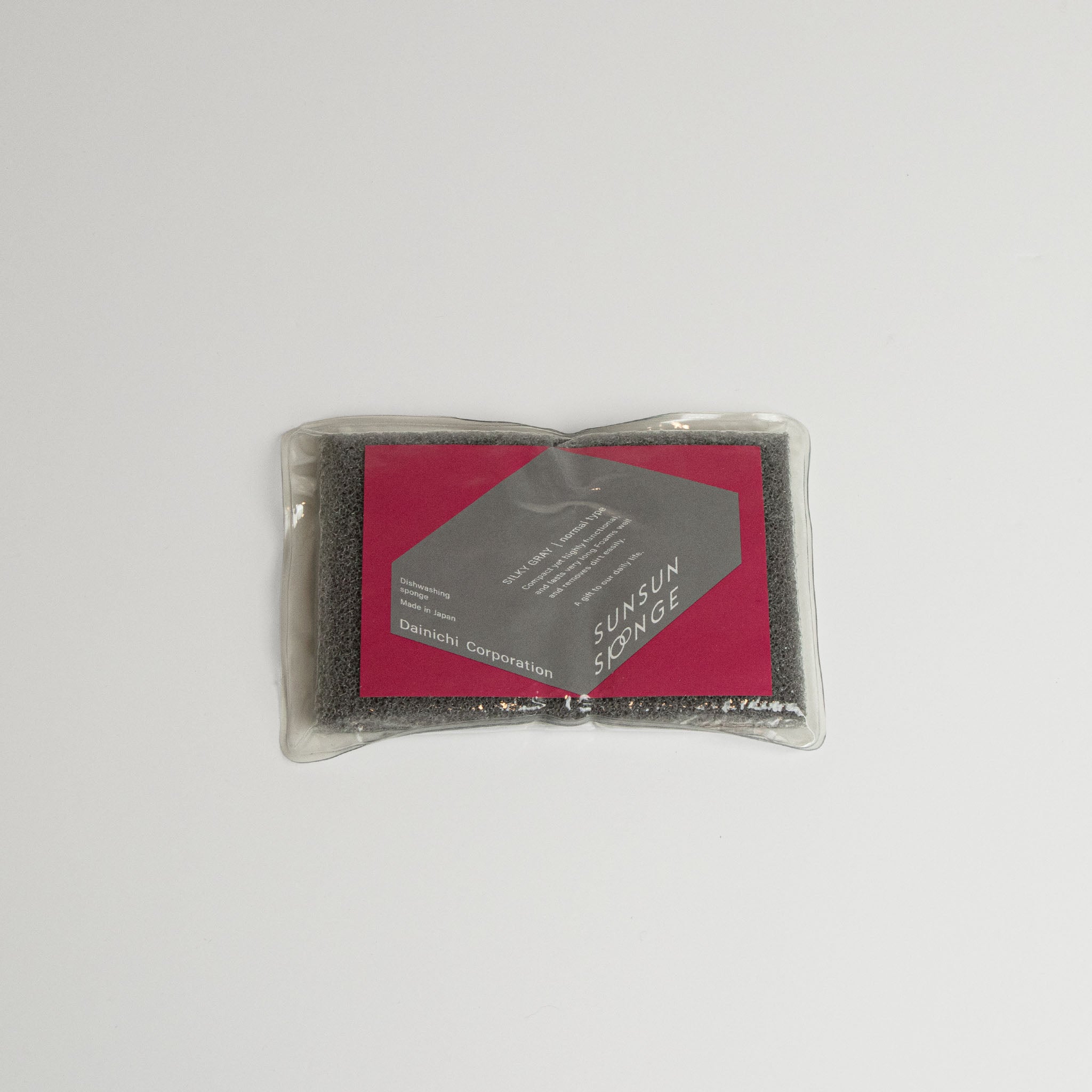 Grey Sunsun sponge in packaging with on a white background