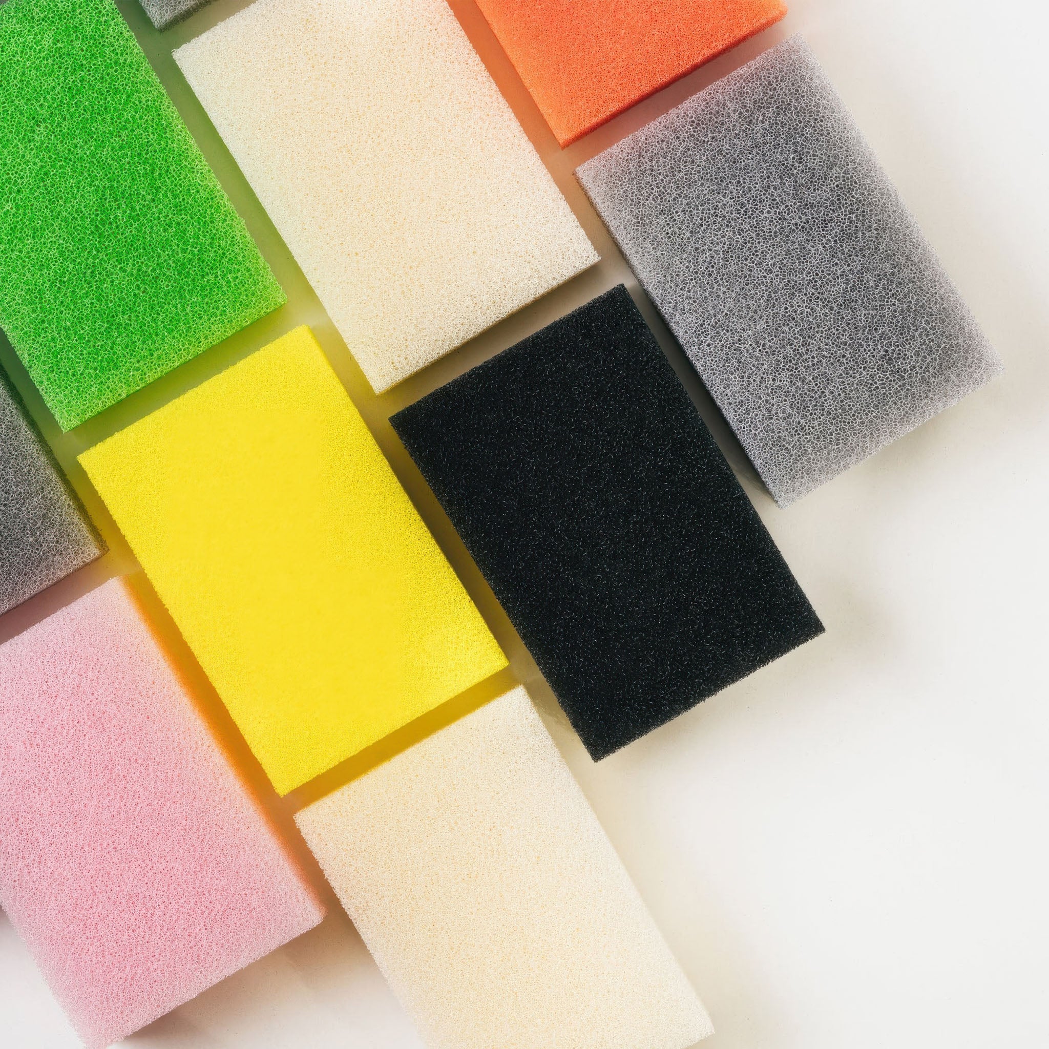 Top view of all of the colored Sunsun sponges on a white background
