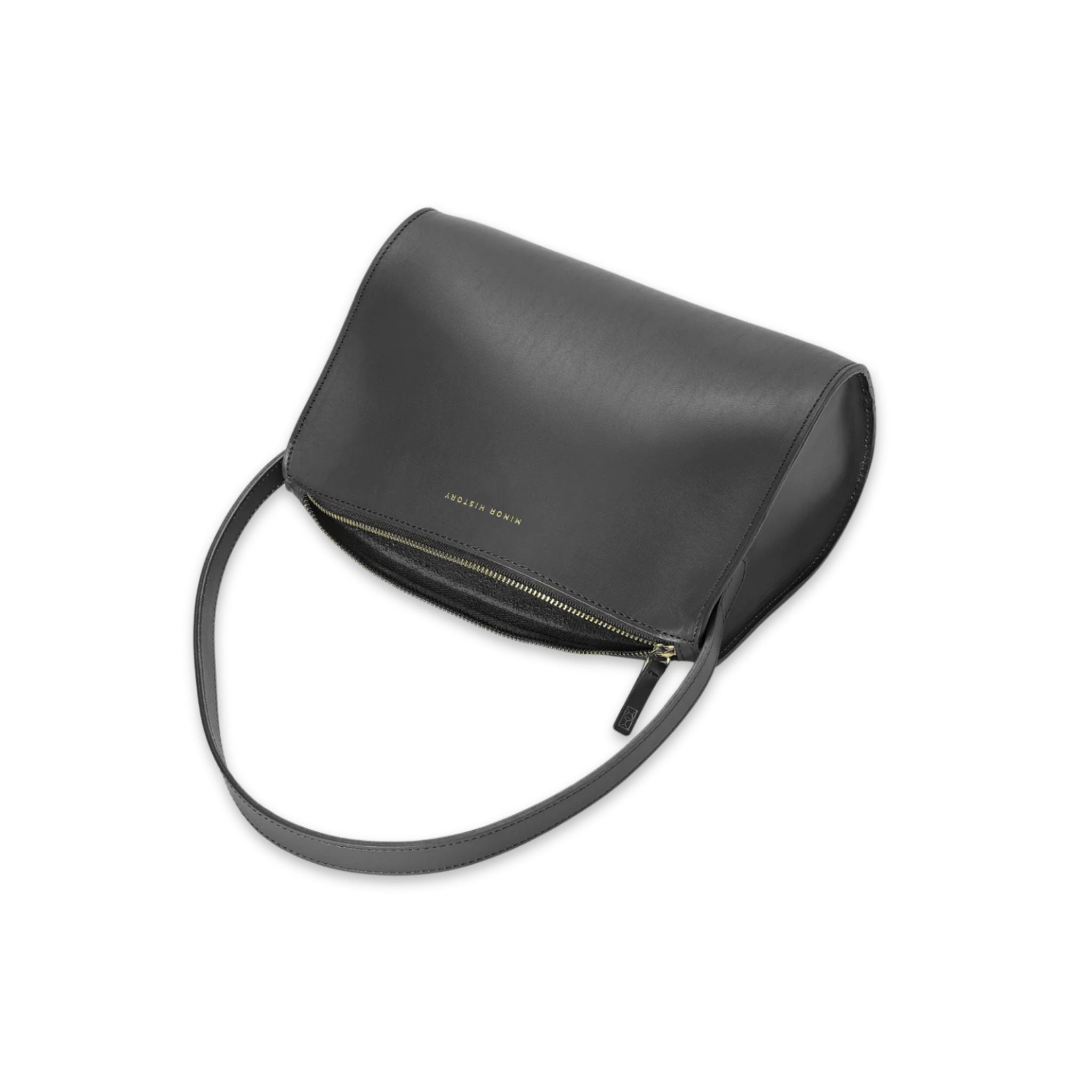Minor History's The Hug Shoulder Bag laying on its side in color black