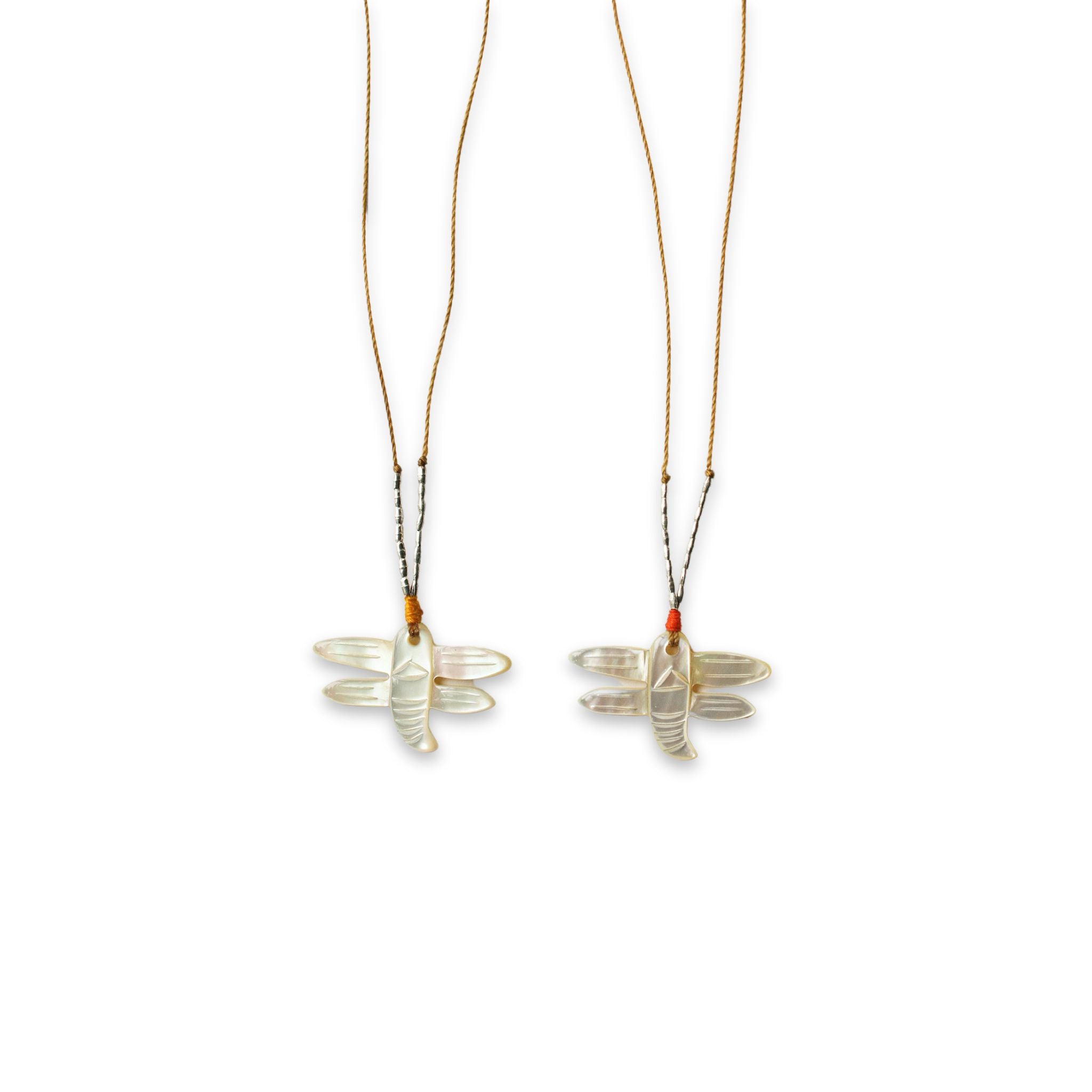 close up image of two see real flowers necklace next to each other with dragonfly design