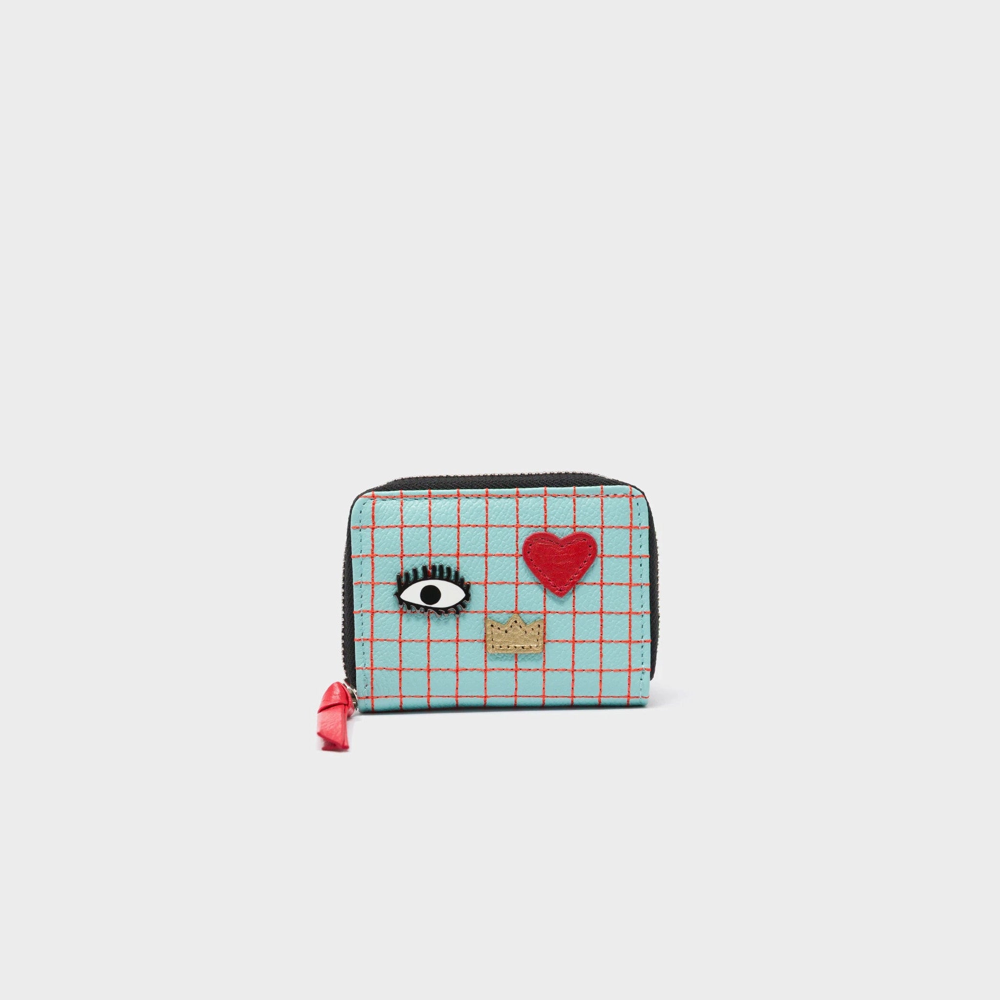 Small wallet with eye, heart, and crown designs on a light gray background