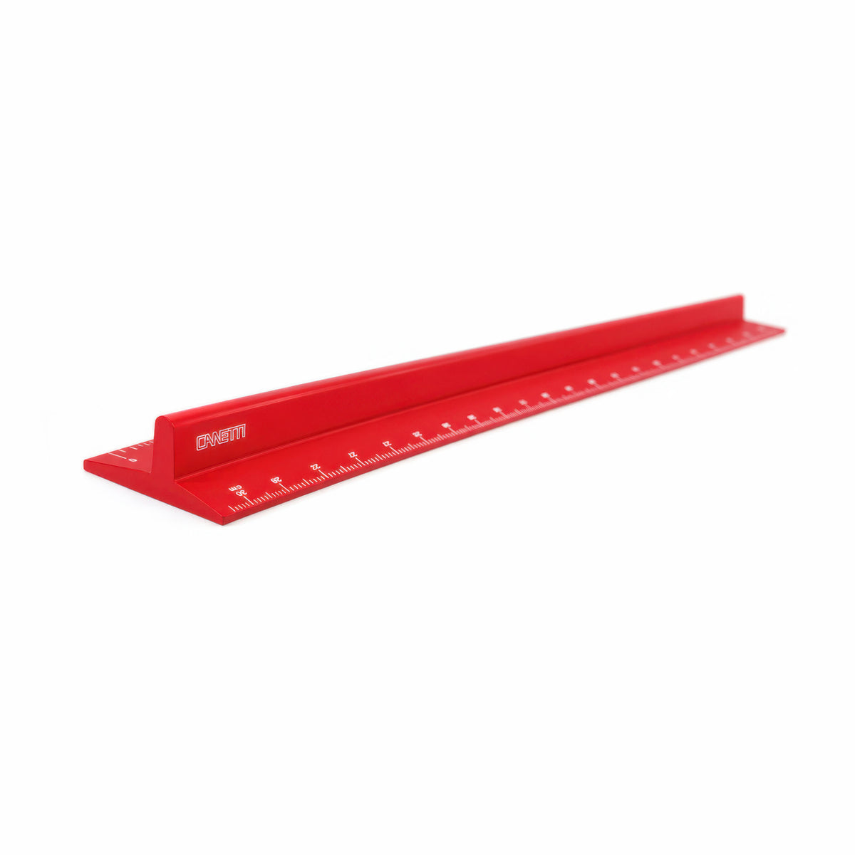 A red metal straightedge ruler with engraved measurement markings and a small white logo, shown diagonally on a plain white background.