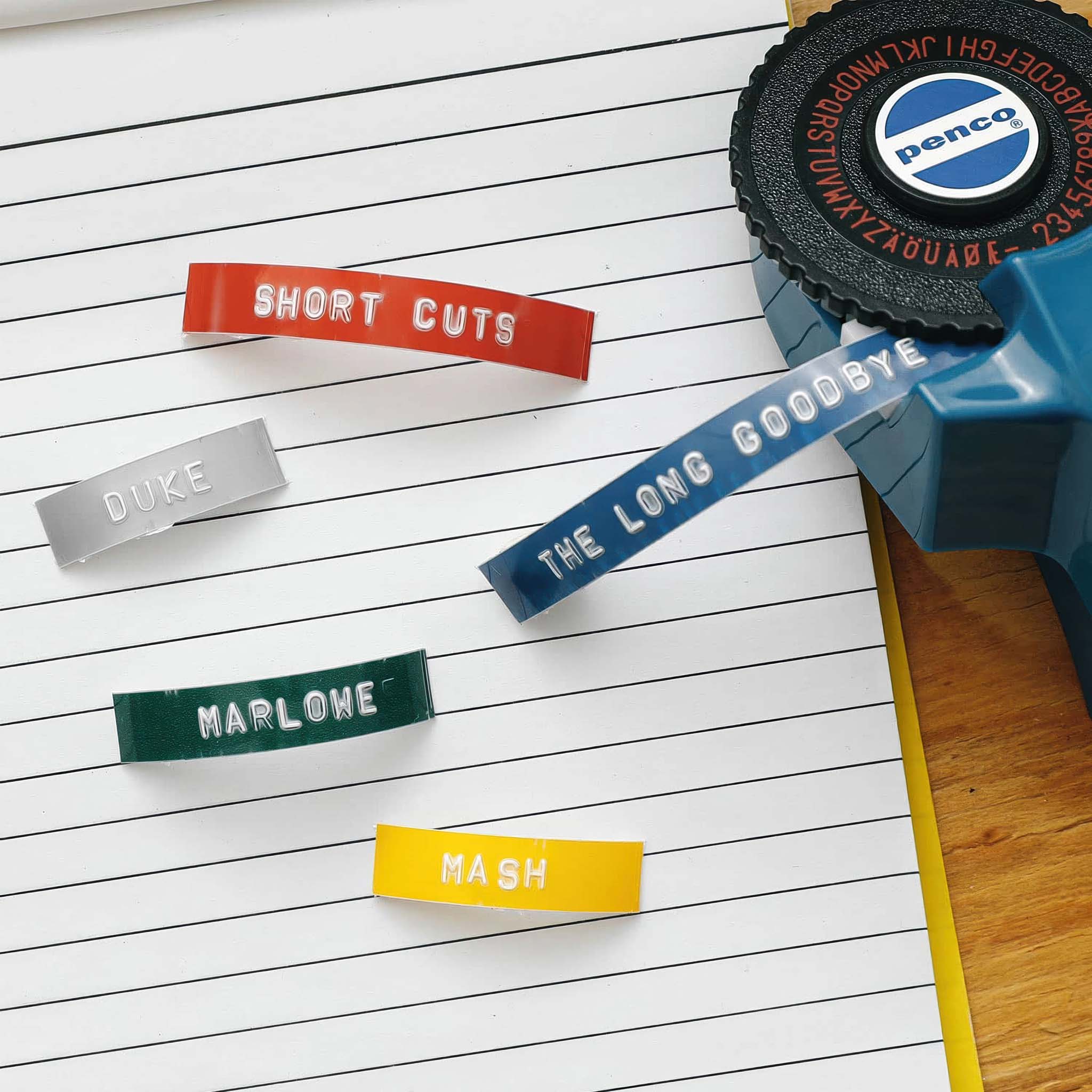 Colorful label tape with text on a lined notebook page