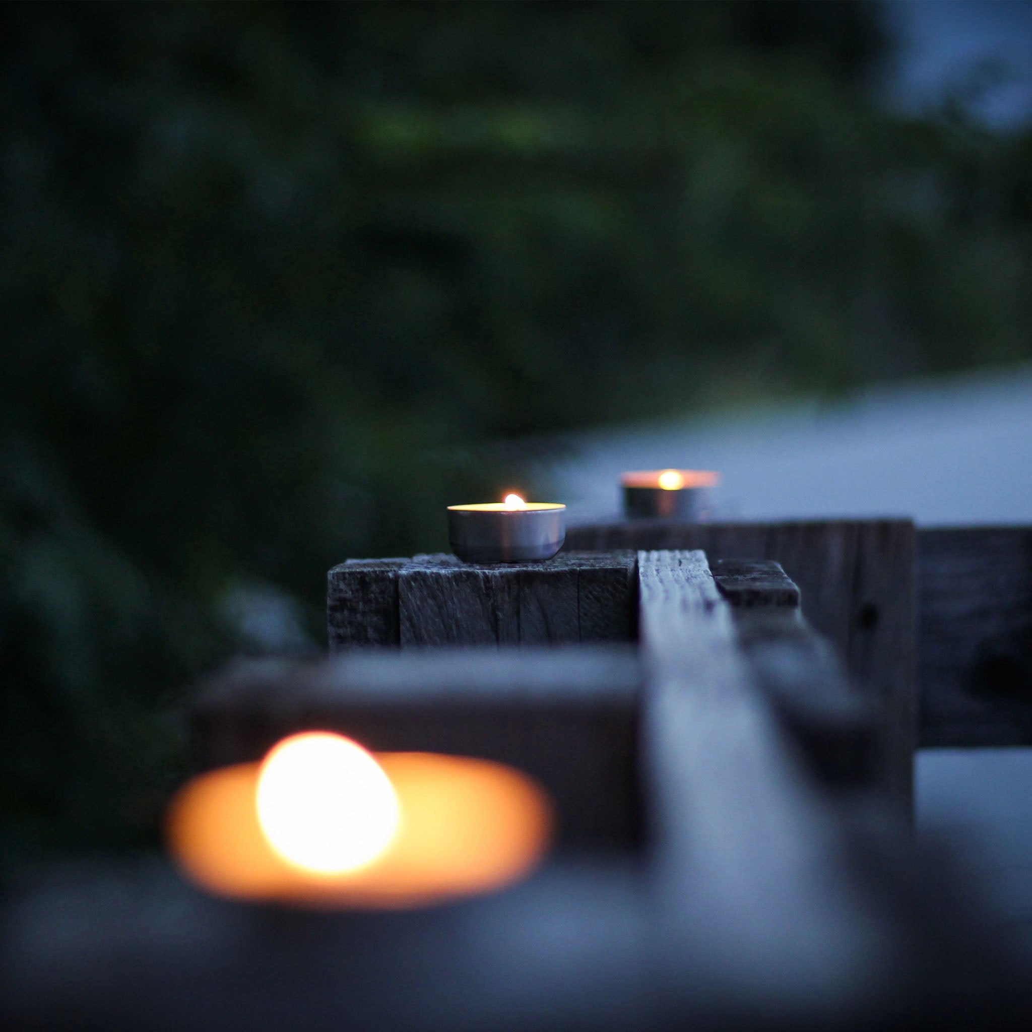 lifestyle image of terralite tealights burning on outdoor fence