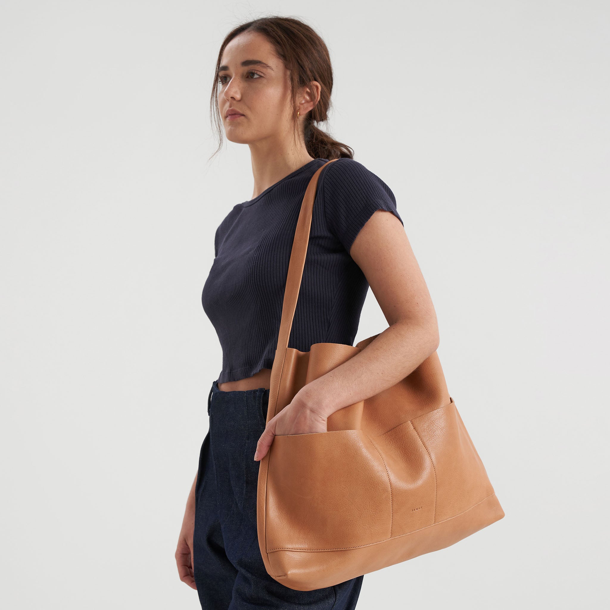 image of bonarda bag color saddle hanging on woman's shoulder