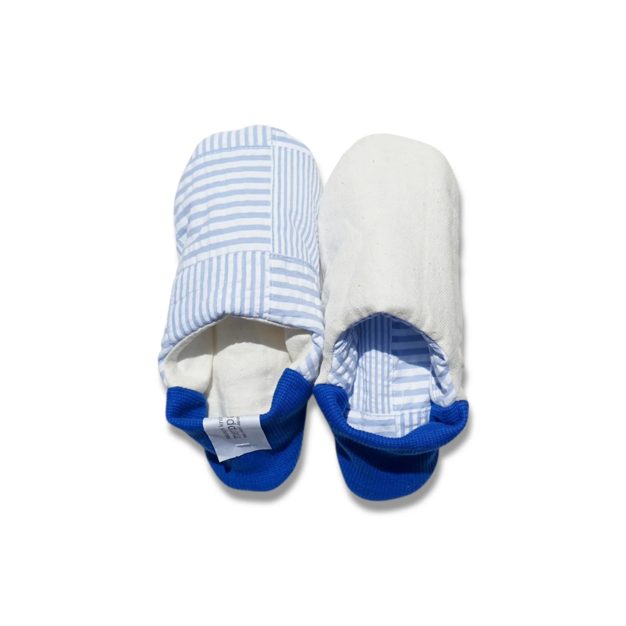 Pair of blue and white striped slippers with blue heels on a white background