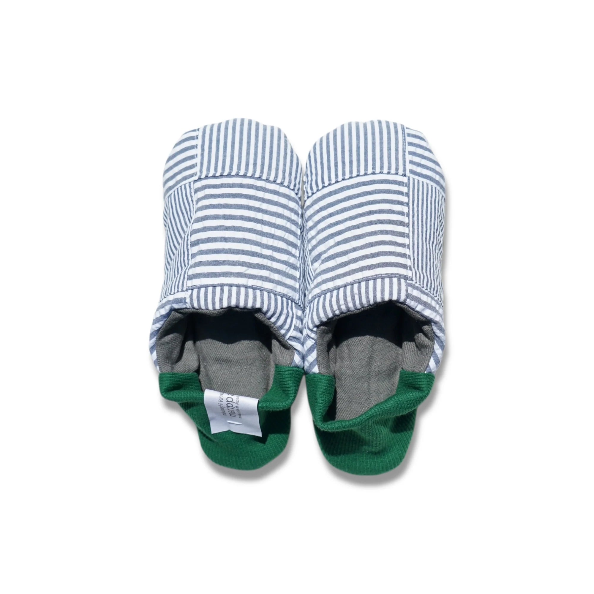 Pair of blue striped slippers with green heels on a white background