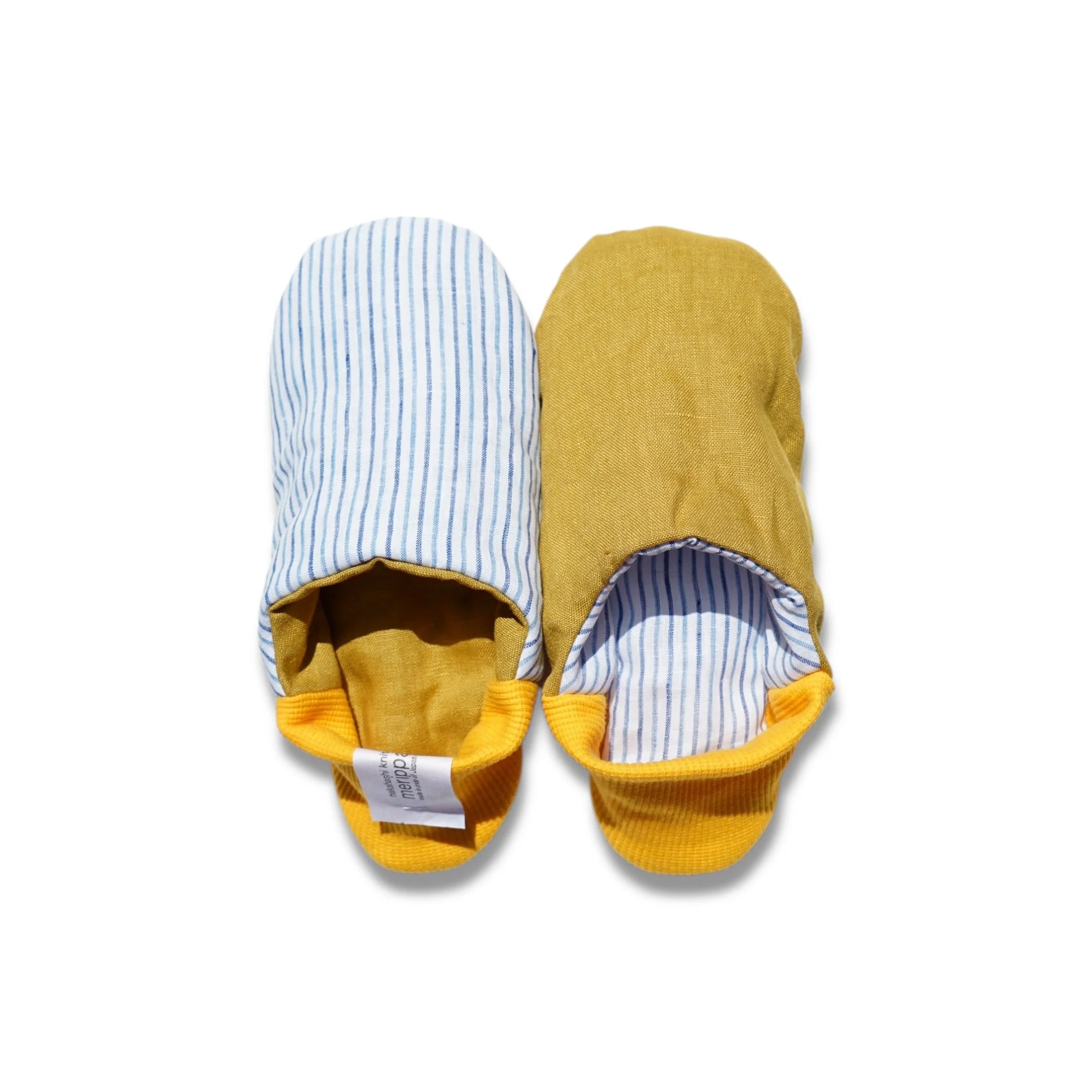 Pair of blue striped slippers with yellow heels on a white background
