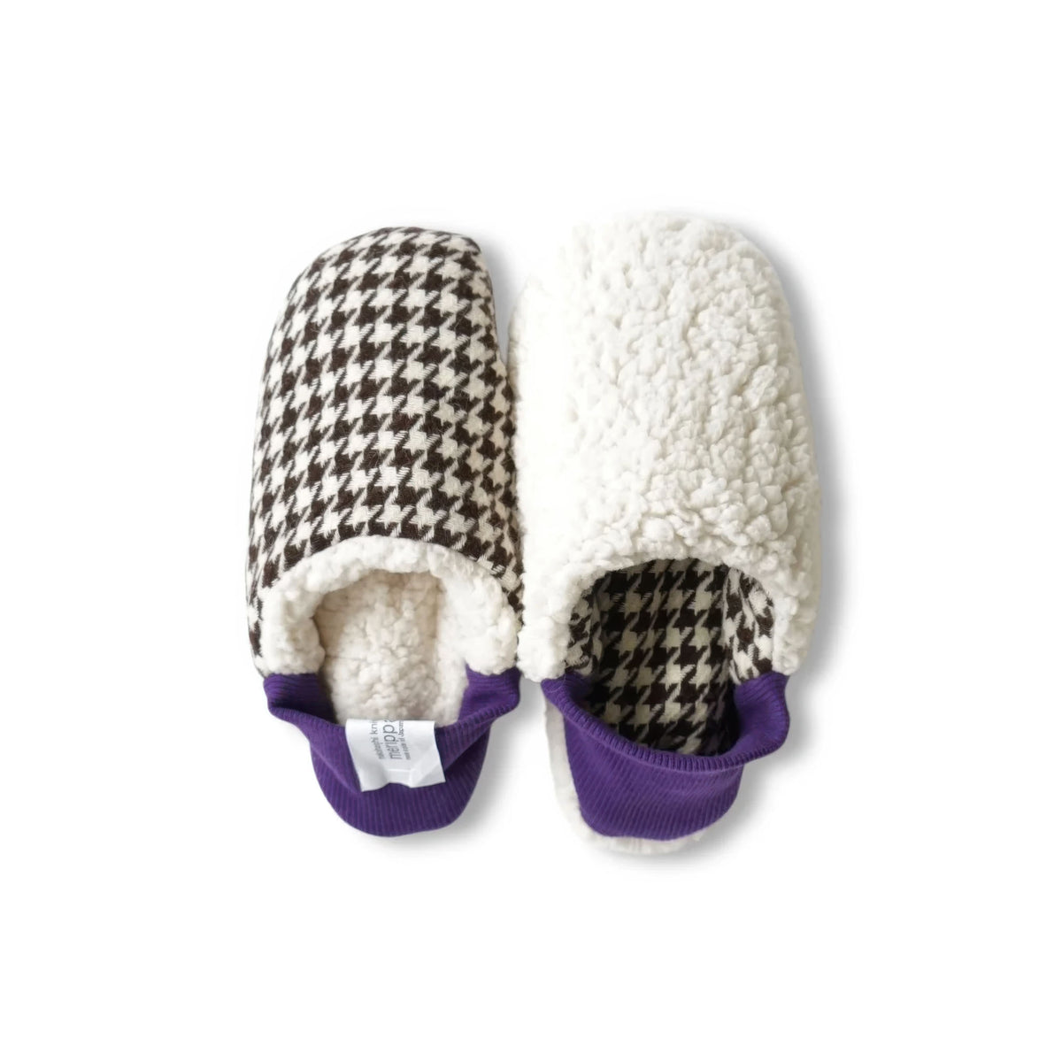 A pair of Merippa slip-on slippers on a white background. One slipper has a brown and cream houndstooth pattern with a cream sherpa lining and a purple trim, while the other is flipped and shows the cream sherpa exterior and the houndstooth interior with purple trim.