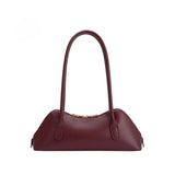 The Dakota burgundy handbag on a white background