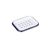 White soap dish with blue rim on a white background