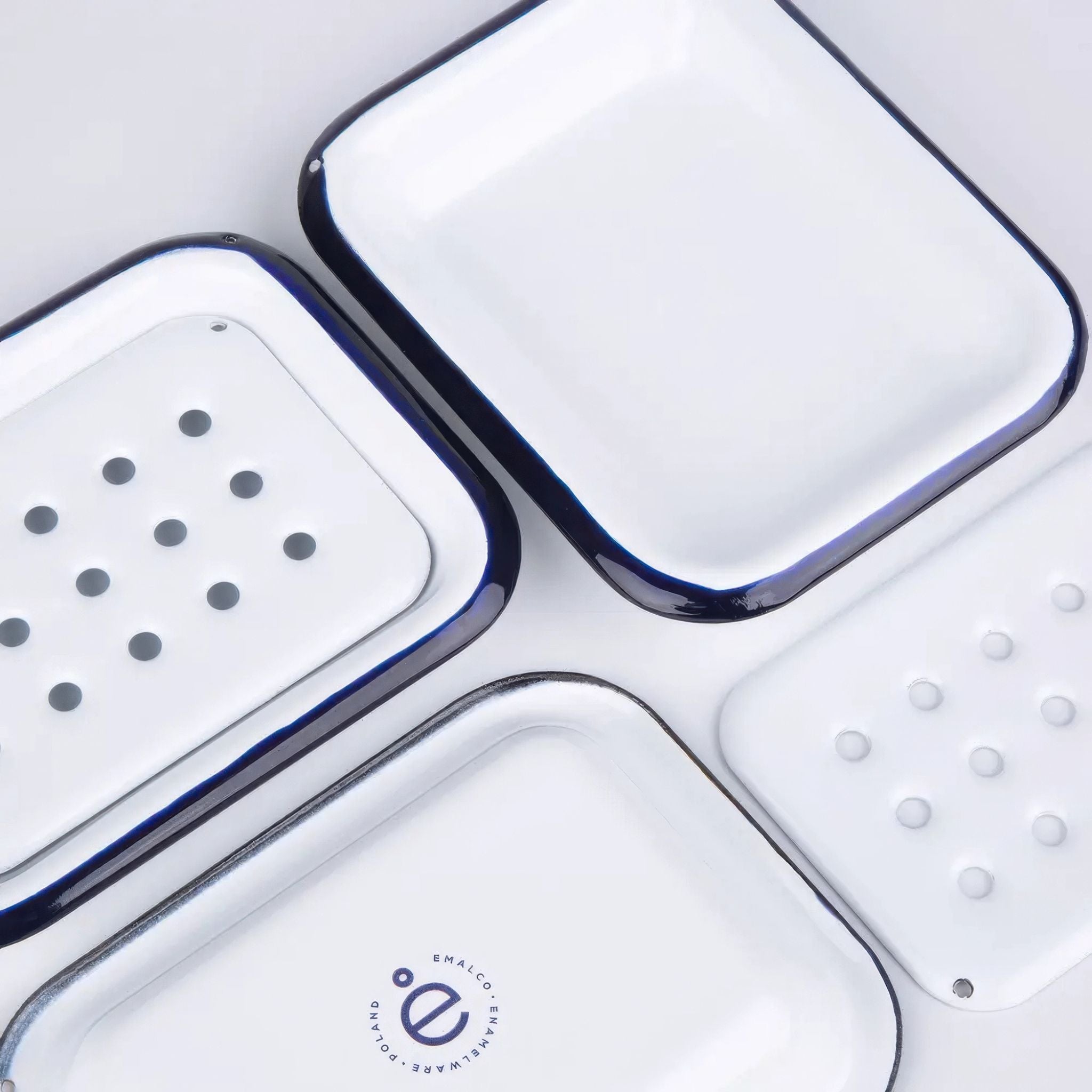 Aesthetic image of white soap dish with blue rim on a white background