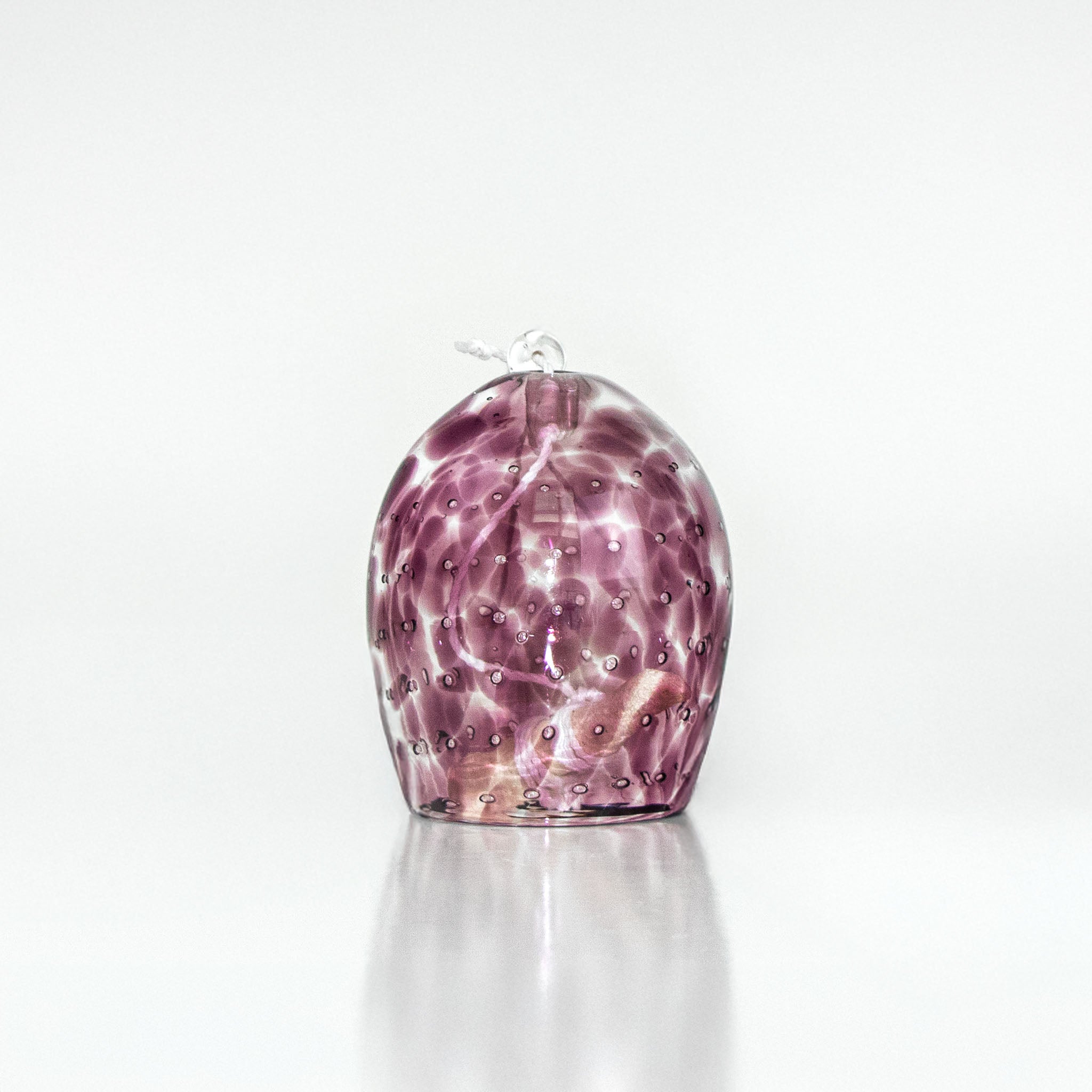 Rose pink marbled glass wind chime on a white background