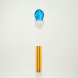  Blue glass Okinawan wind chime with yellow handwoven tab by Miyahira Studio, suspended on a white background.