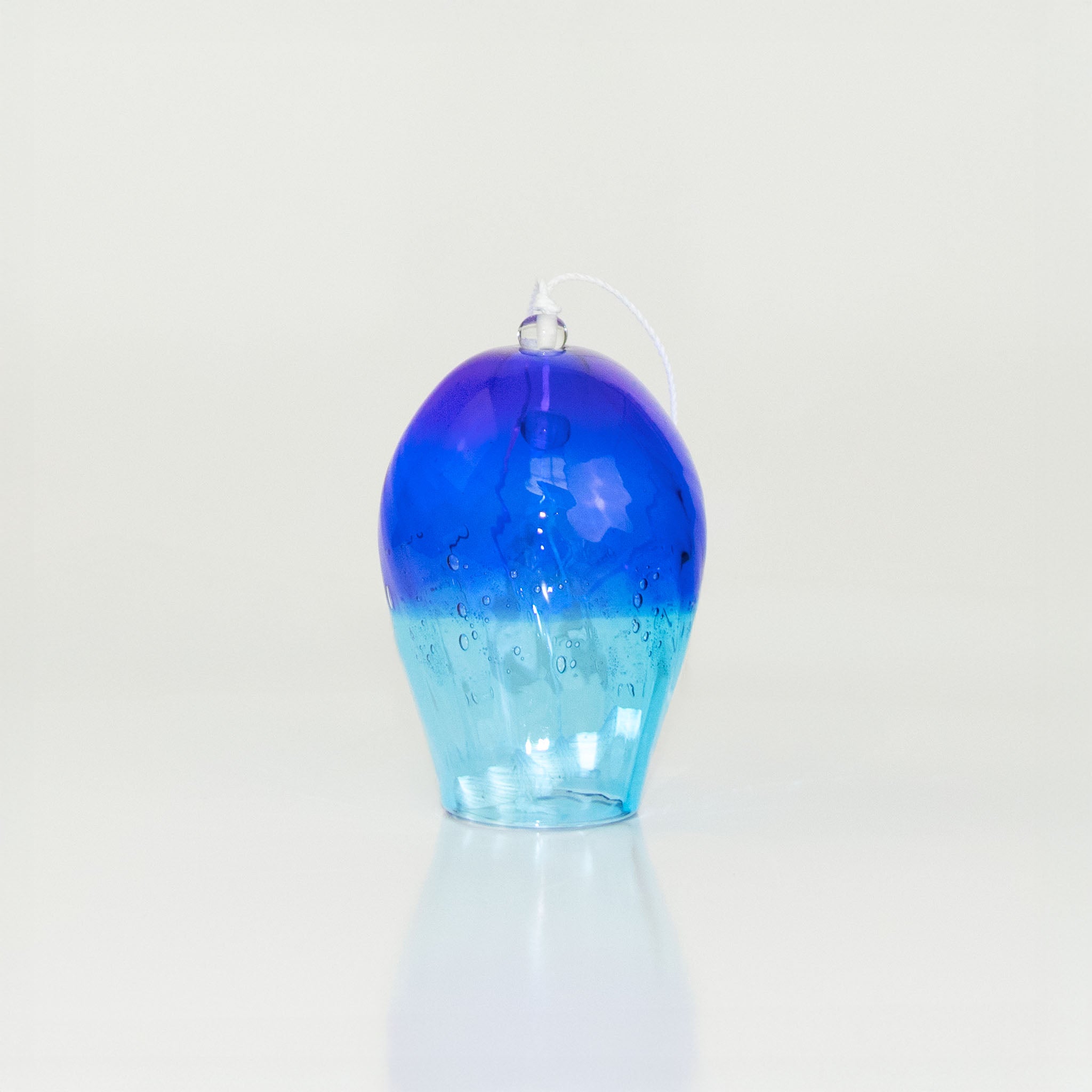 Blue glass wind chime on a white background