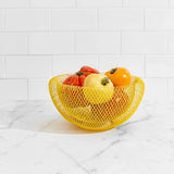 image of MoMA wire mesh bowl color yellow filled with tomatoes