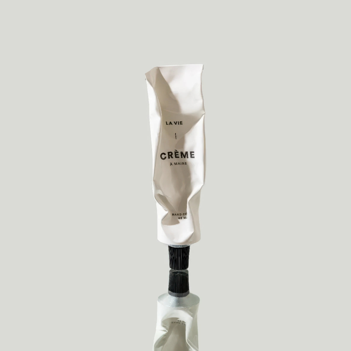 image of hand creme tube on reflective surface