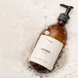 image of hand soap bergamot bottle surrounded by foam bubbles