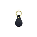 Black leather keychain with gold ring on a white background