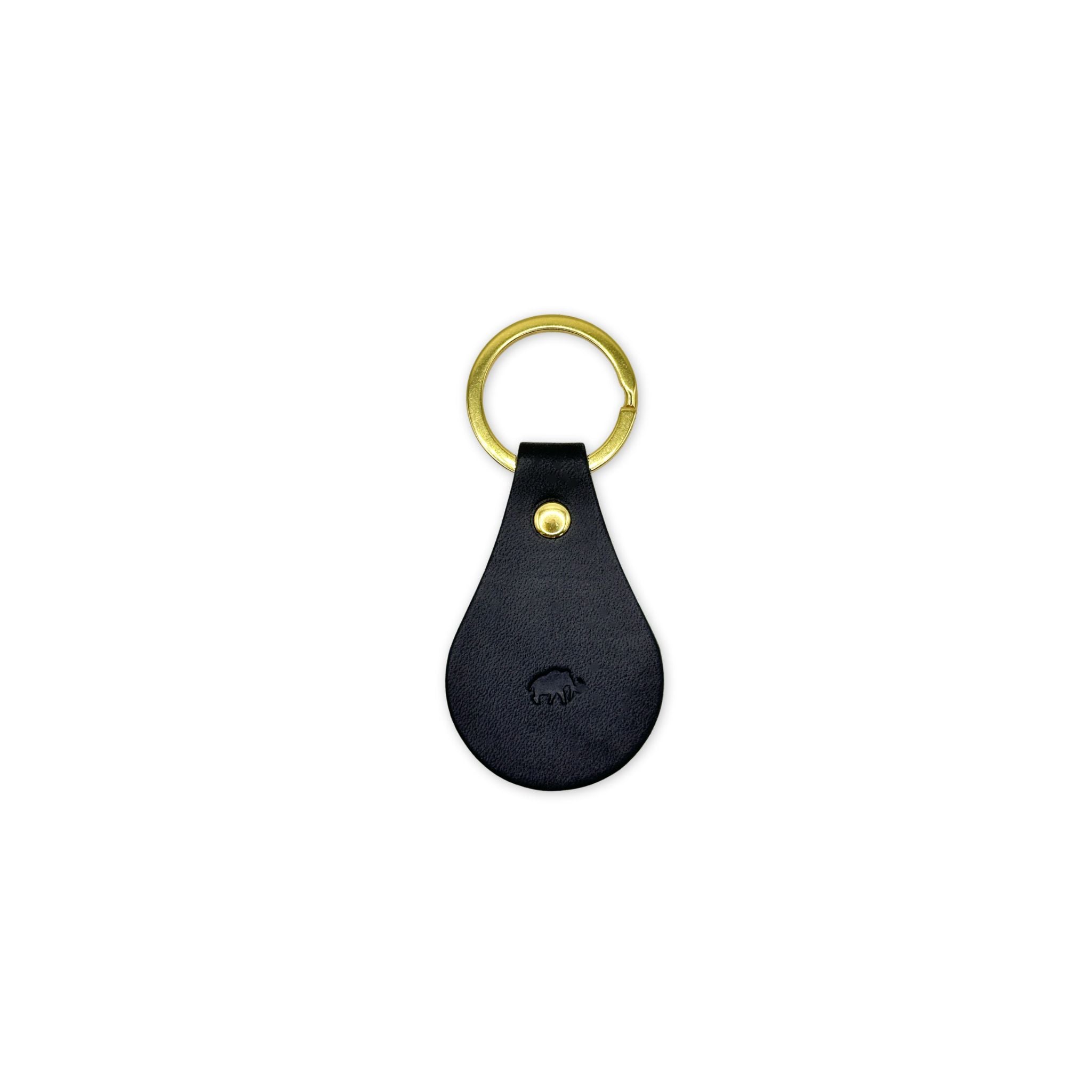 Black leather keychain with gold ring on a white background