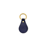 Navy blue leather keychain with gold ring and clasp on a white background
