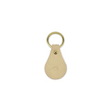 Tusk leather keychain with gold ring on a white background