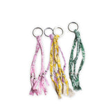 Four keychains with bandana patterns on a white background