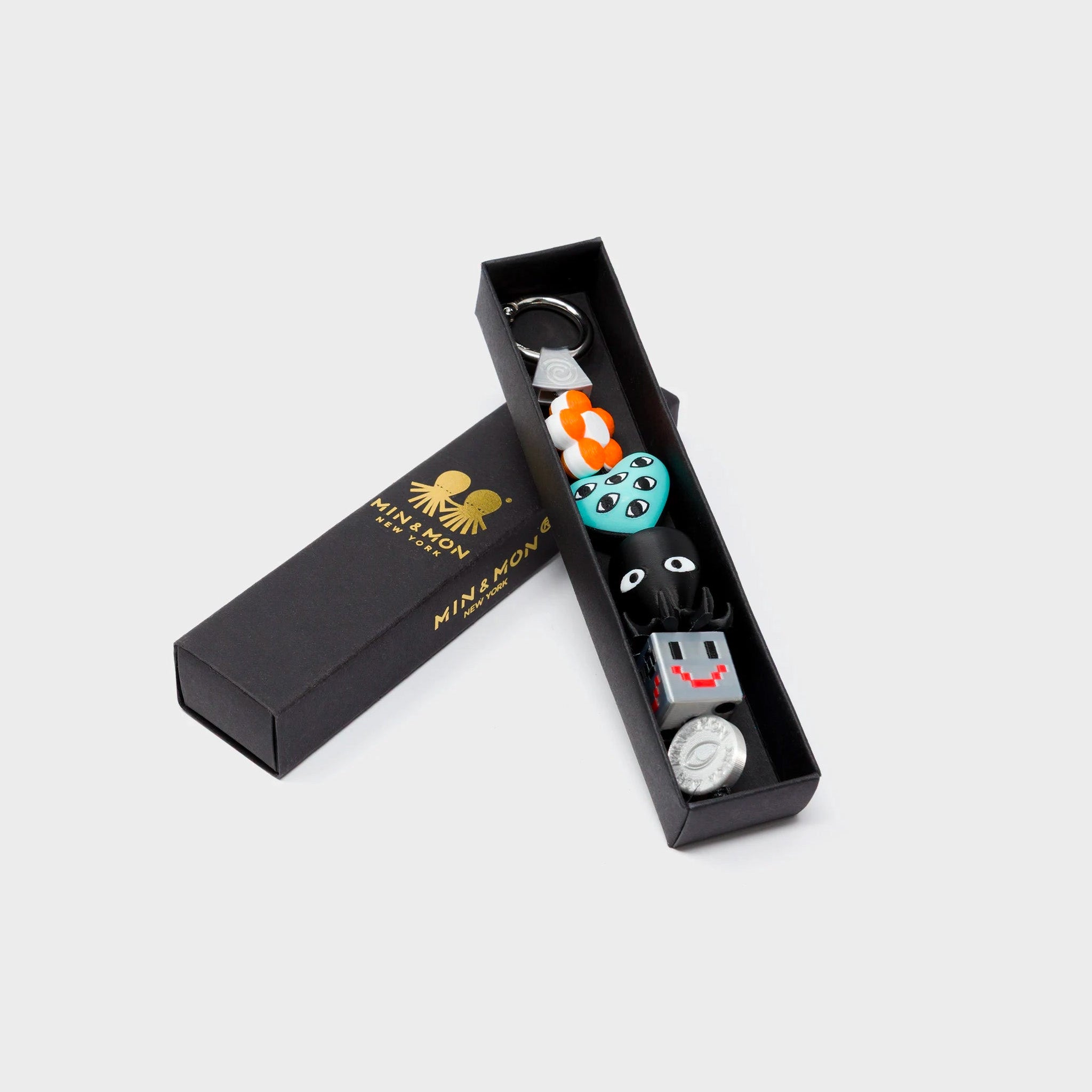 Min & Mon's Bloomoo Charm - Orange and Blue 3D Printed Bioplastic Keychain in its retail packaging box