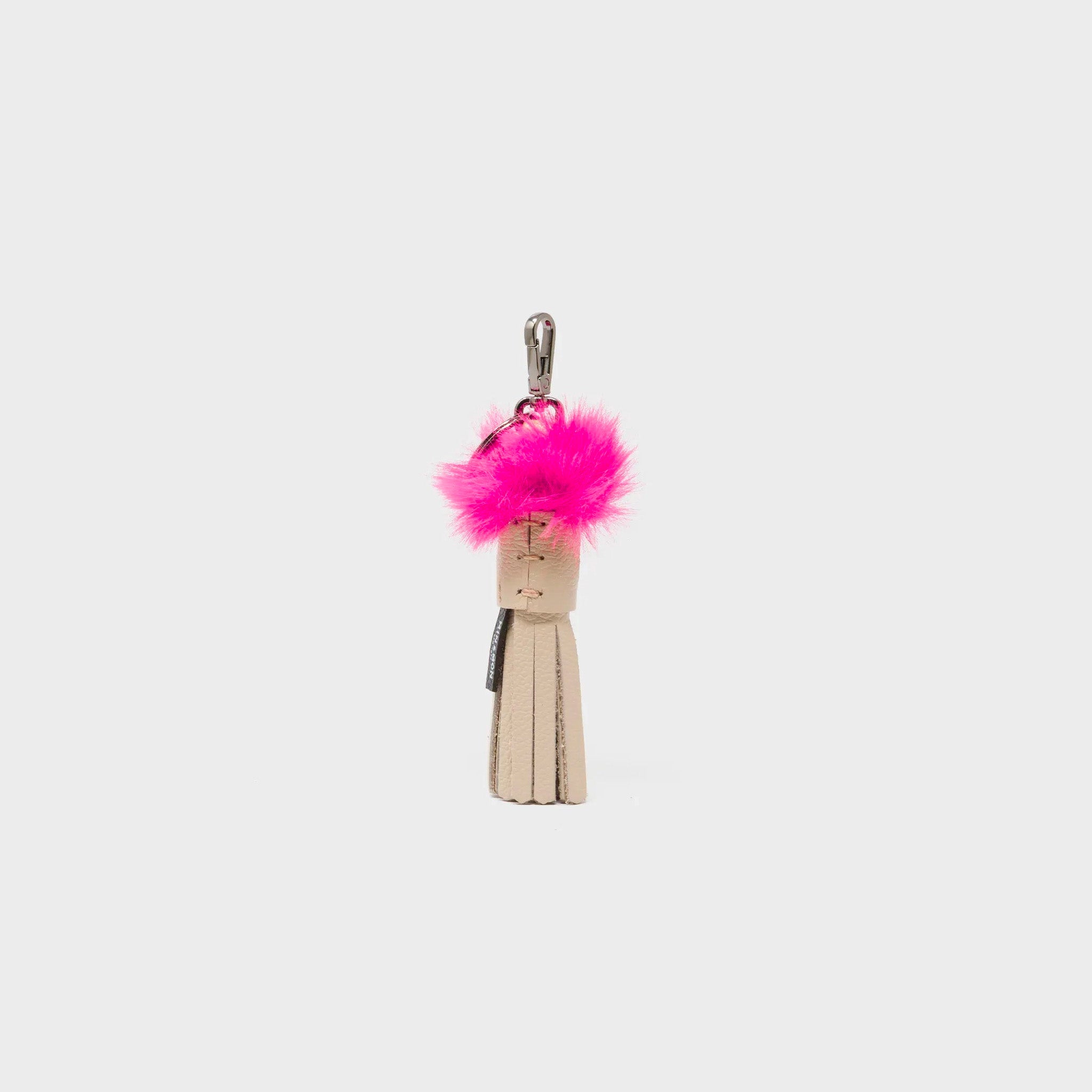 The backside of Min & Mon's Callie Marie Mayne - Beige Leather and Fucshia Faux Fur tassle on a white background