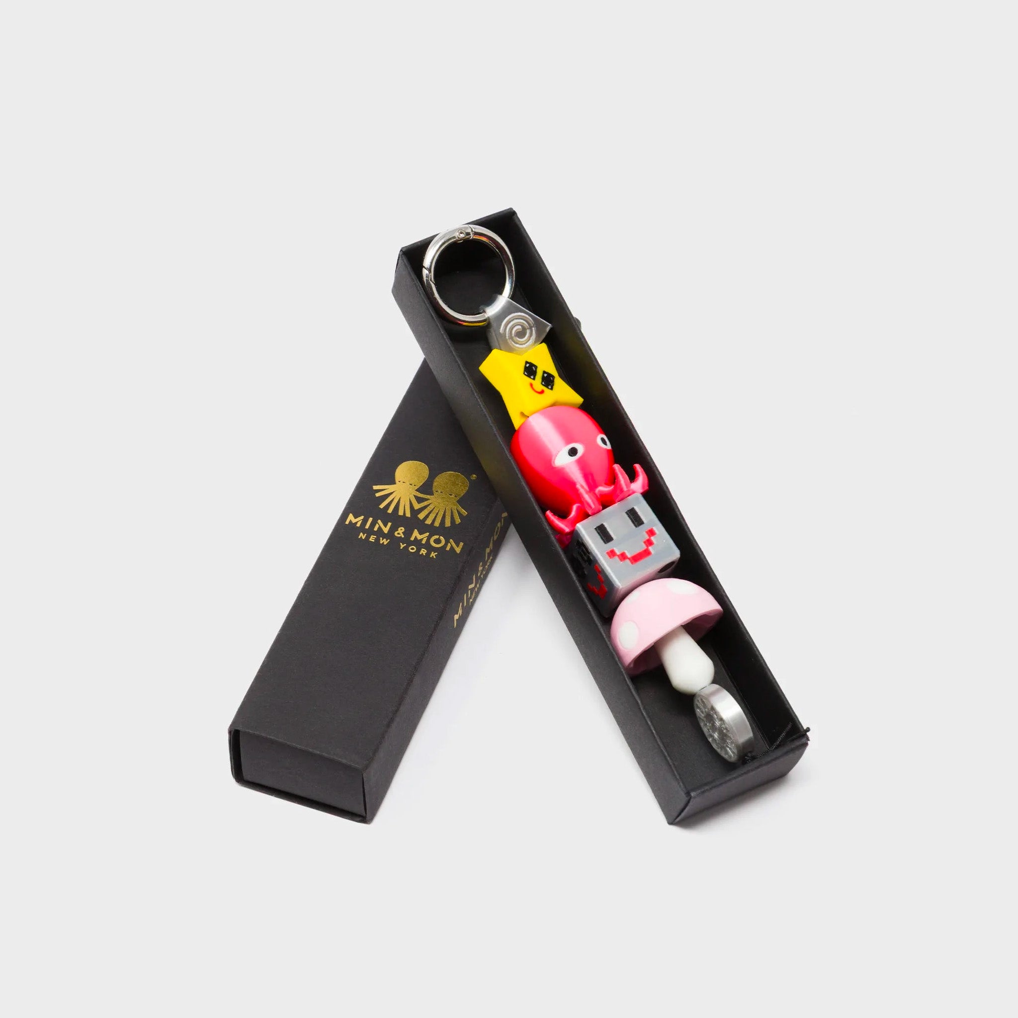 Min & Mon's Cosmo Critter Stack Charm - Fucshia and Yellow 3D Printed Bioplastic Keychain in its retail packaging box