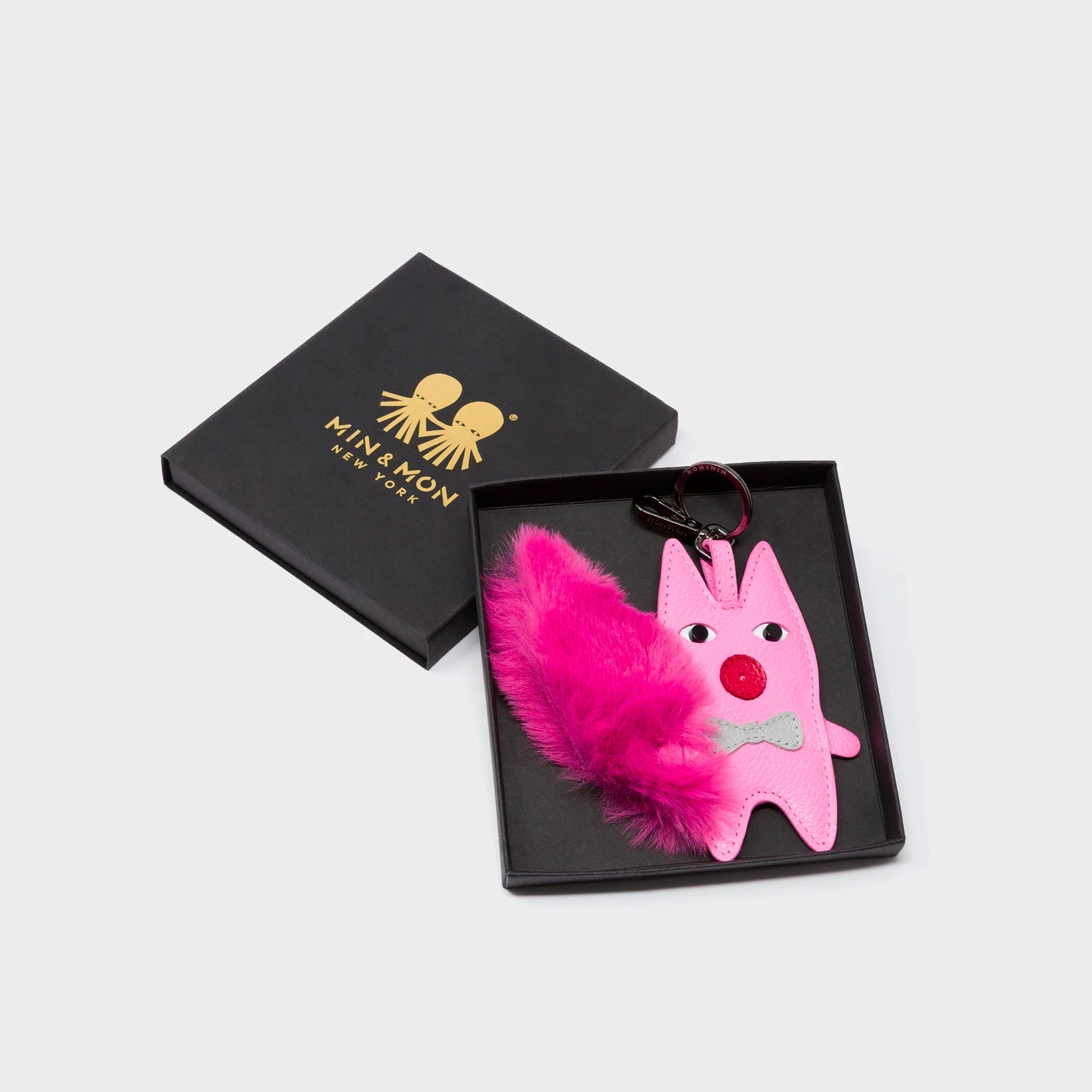 Min & Mon's Flufftail Charm - Bubblegum Pink Leather Keychain in its retail packaging box