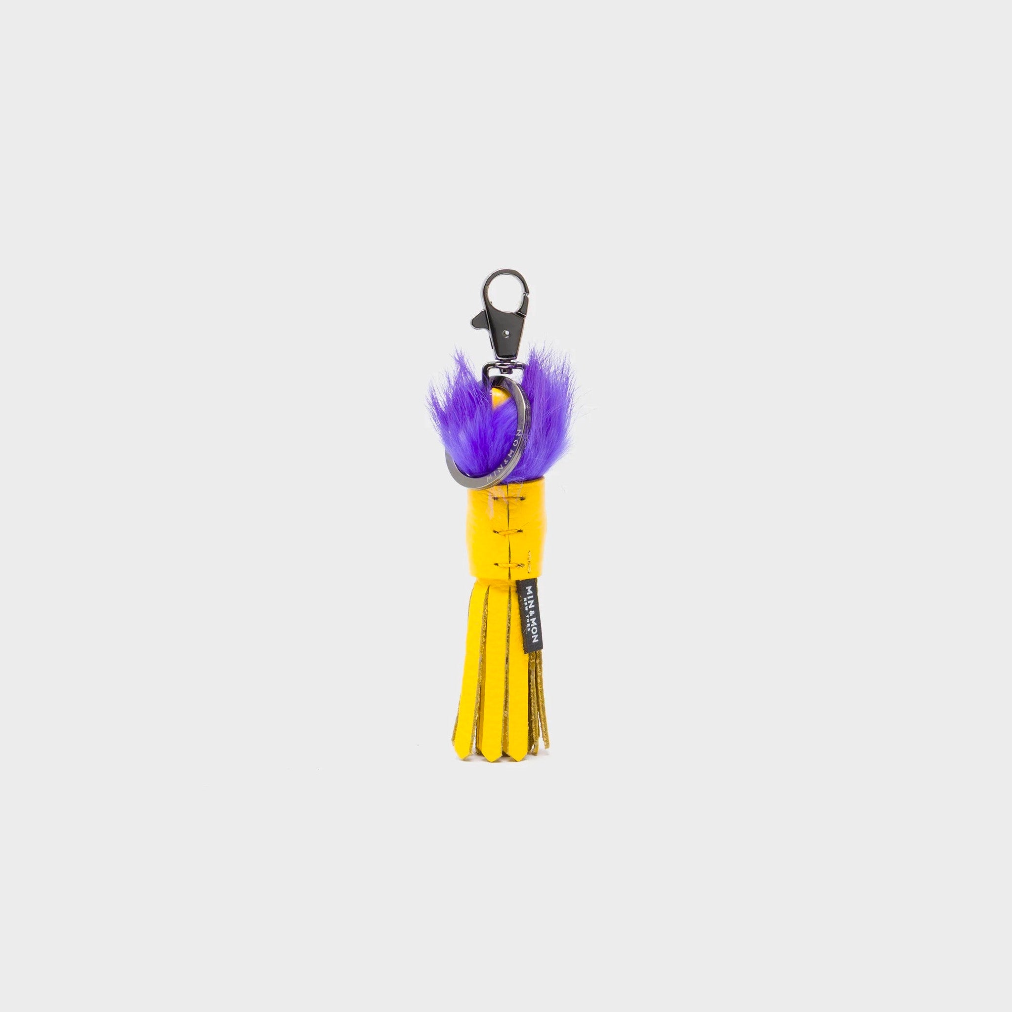 Back of Min & Mon's Markets - Callie Marie Mayne - Light Yellow Leather and Purple Fur Keychain on a white background