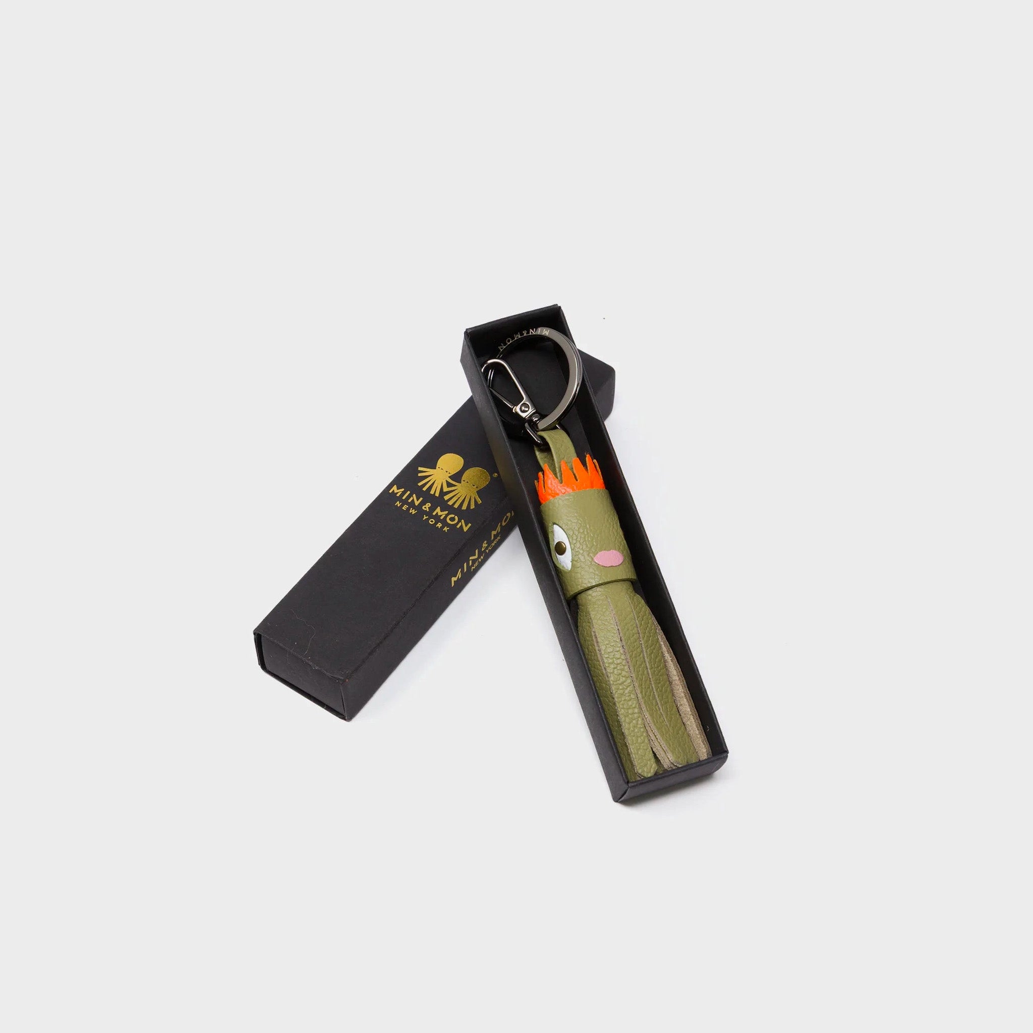 Min & Mon's Markets - Queen Callie Marie Charm - Moss Green Leather Keychain in its retail packaging