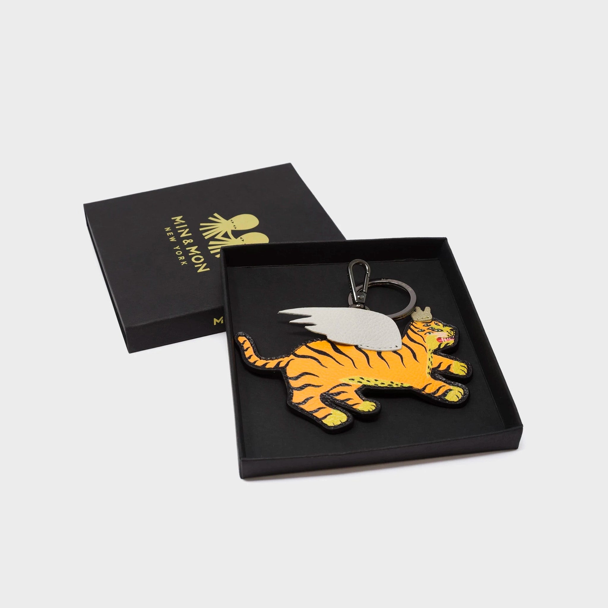 Min & Mon's Theo the Tiger keychain in its  retail packaging box