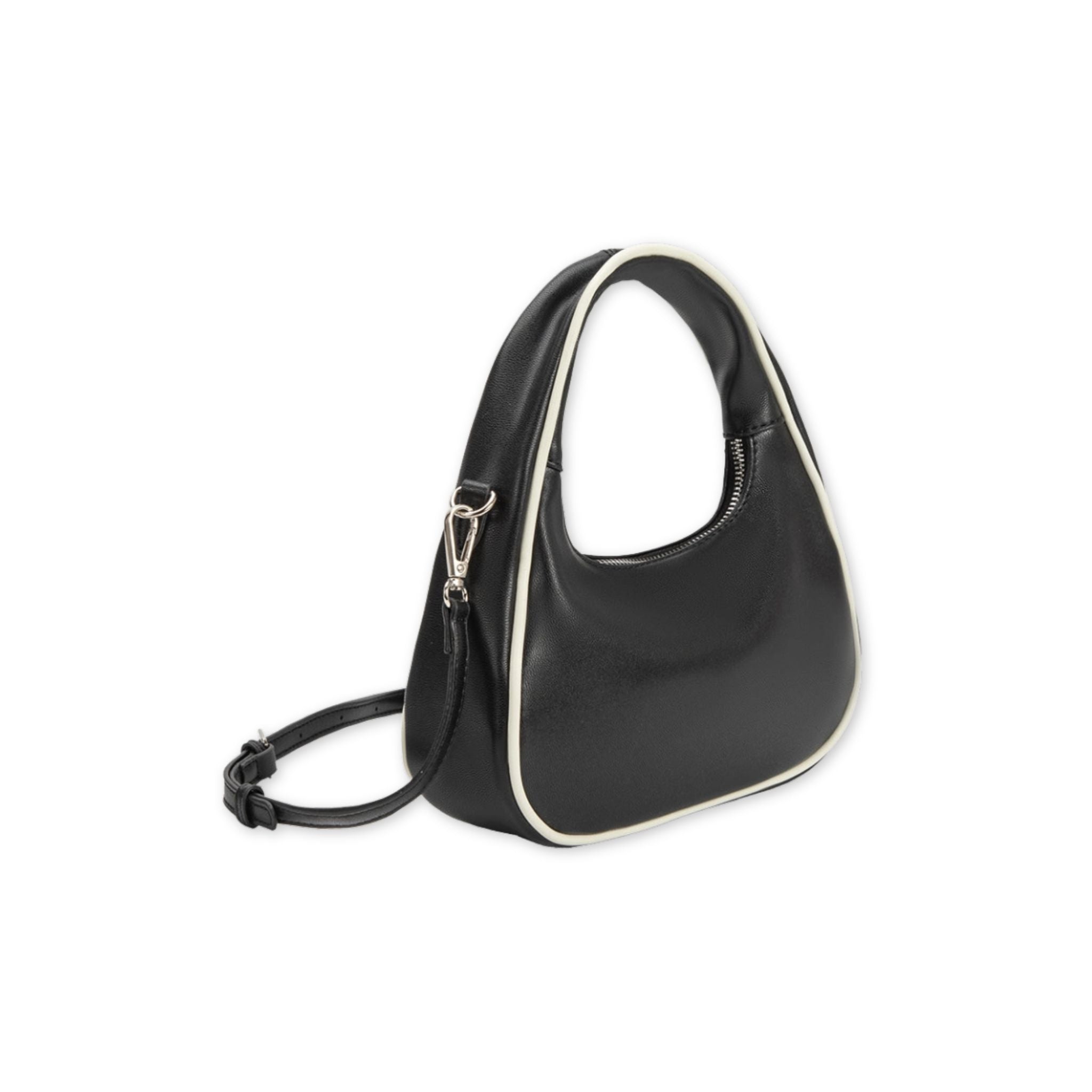 Angled view of a black handbag with white trim on a white background