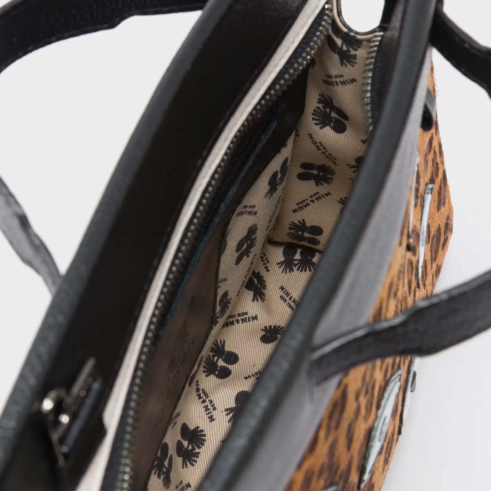 Close up of inside Min & Mon's Vali Crossbody Small Animal Print Leather Bag - Eyes Applique Adjustable Handle