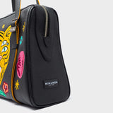 Angled view of Min & Mon' Esther Black Satchel Bag - Happy Tiger Embroidery 