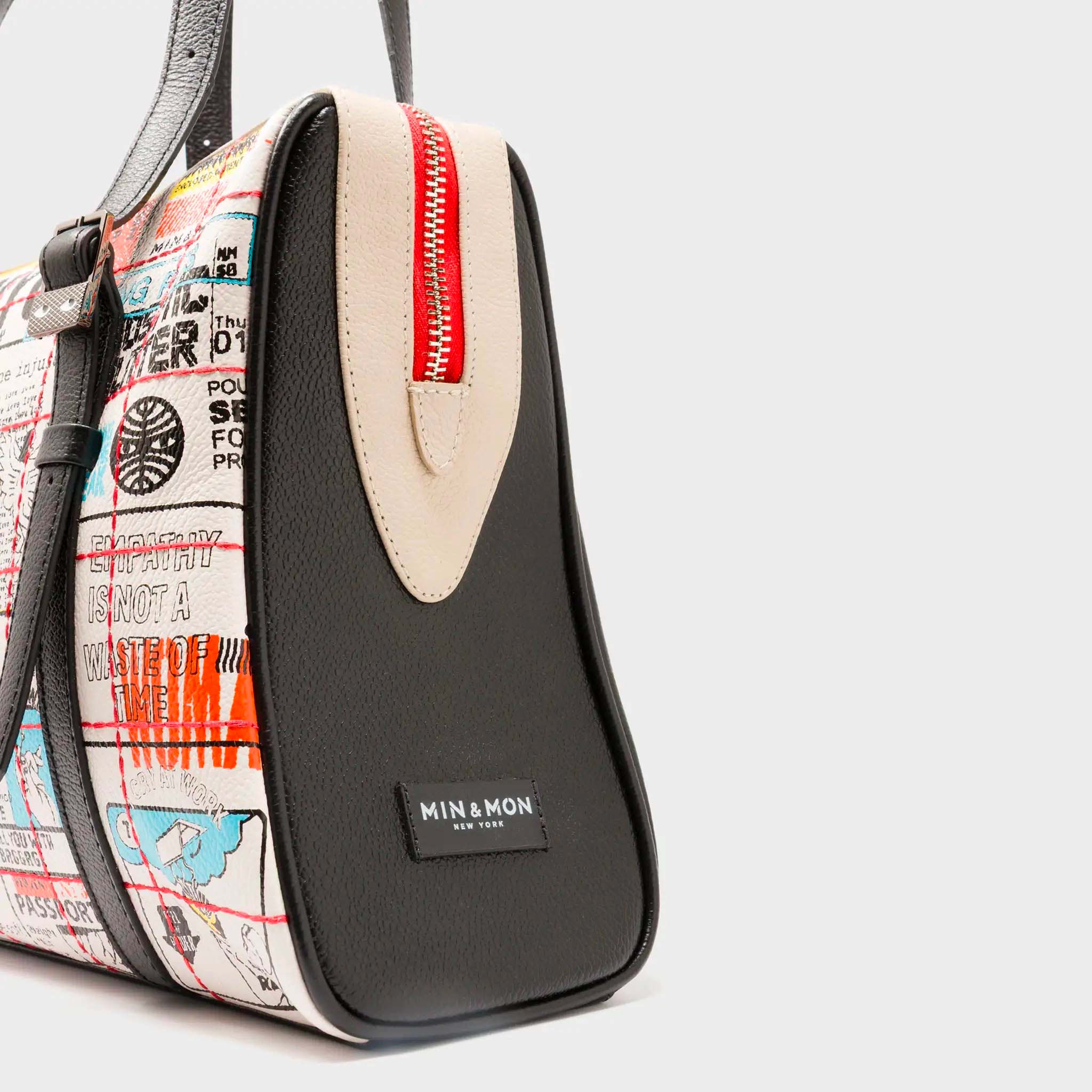 Angled view of Min & Mon's Esther Cream and Black Satchel Bag - Kind Type Design