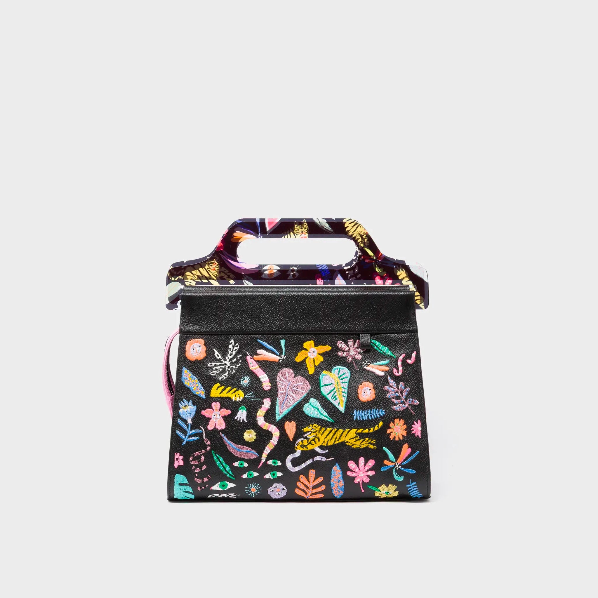 Black handbag with colorful floral and abstract patterns on a light gray background