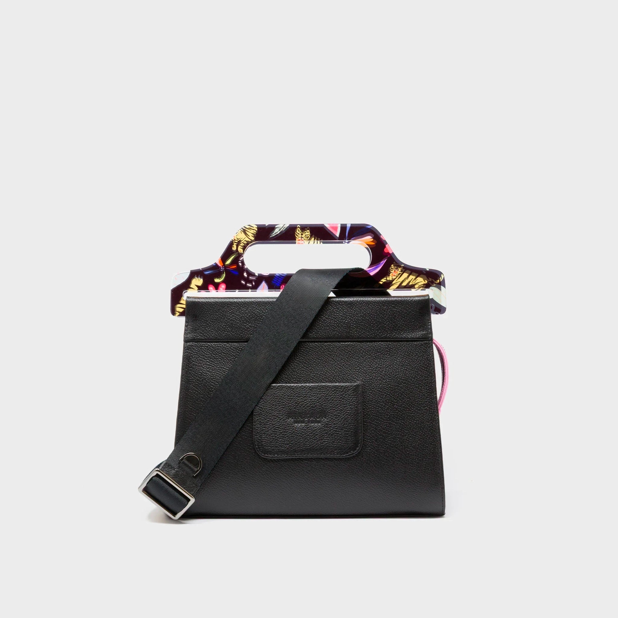 Black handbag with a colorful floral handle on a light gray background