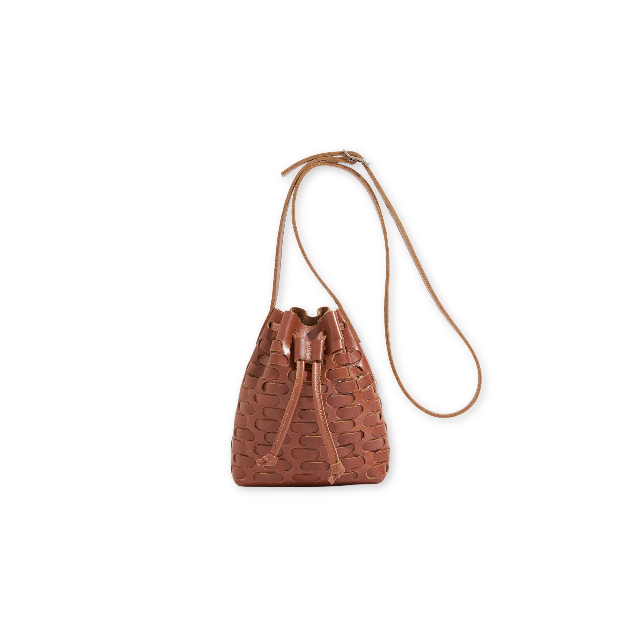 Brown leather drawstring bucket bag on a white background